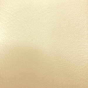 May include: A close-up of a smooth, off-white textured surface.