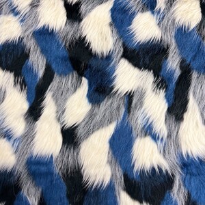 May include: Abstract faux fur fabric with a blue, white, and black color scheme. The fabric has a soft, fluffy texture.