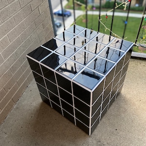 Black glossy tile cube table with white grout