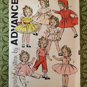 May include: An Advance sewing pattern envelope, number 9603, size 12, featuring illustrations of six outfits for a doll. The cover displays various clothing styles including dresses, a coat with a hat, and pants, with numbered labels for each design.