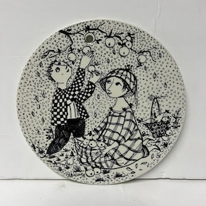May include: Black and white illustration of two people picking apples from a tree. The woman is wearing a plaid dress and a hat. The man is wearing a checkered shirt and pants. They are both holding baskets of apples.