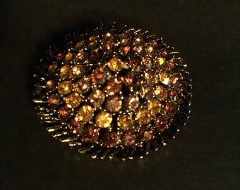 Amber and gold rhinestone brooch. Swirl pattern