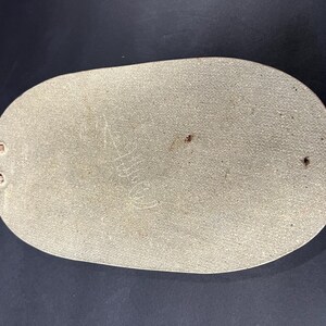 May include: A light grey oval-shaped serving tray with a textured surface and a copper-coloured handle.