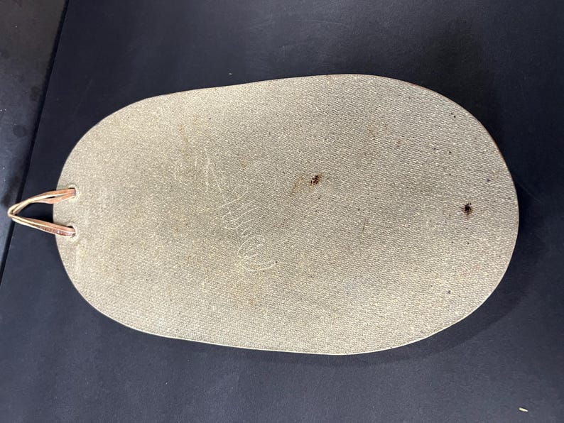 May include: A light grey oval-shaped serving tray with a textured surface and a copper-coloured handle.