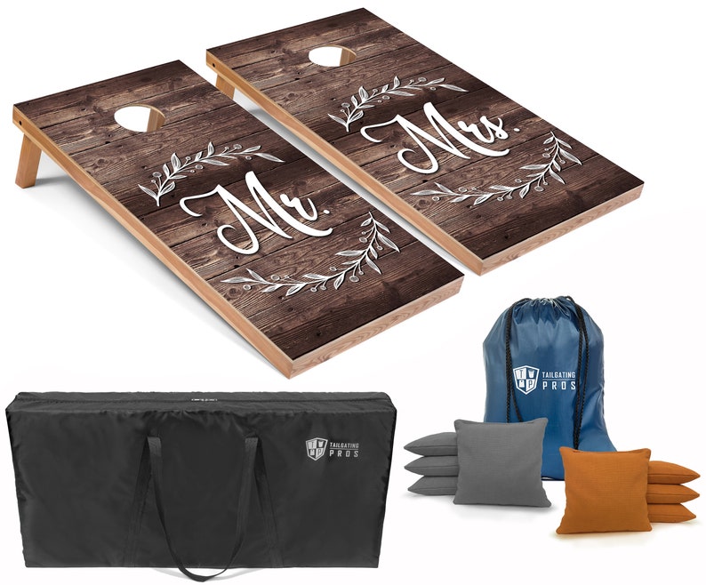 Woodgrain cornhole boards with "Mr." and "Mrs."