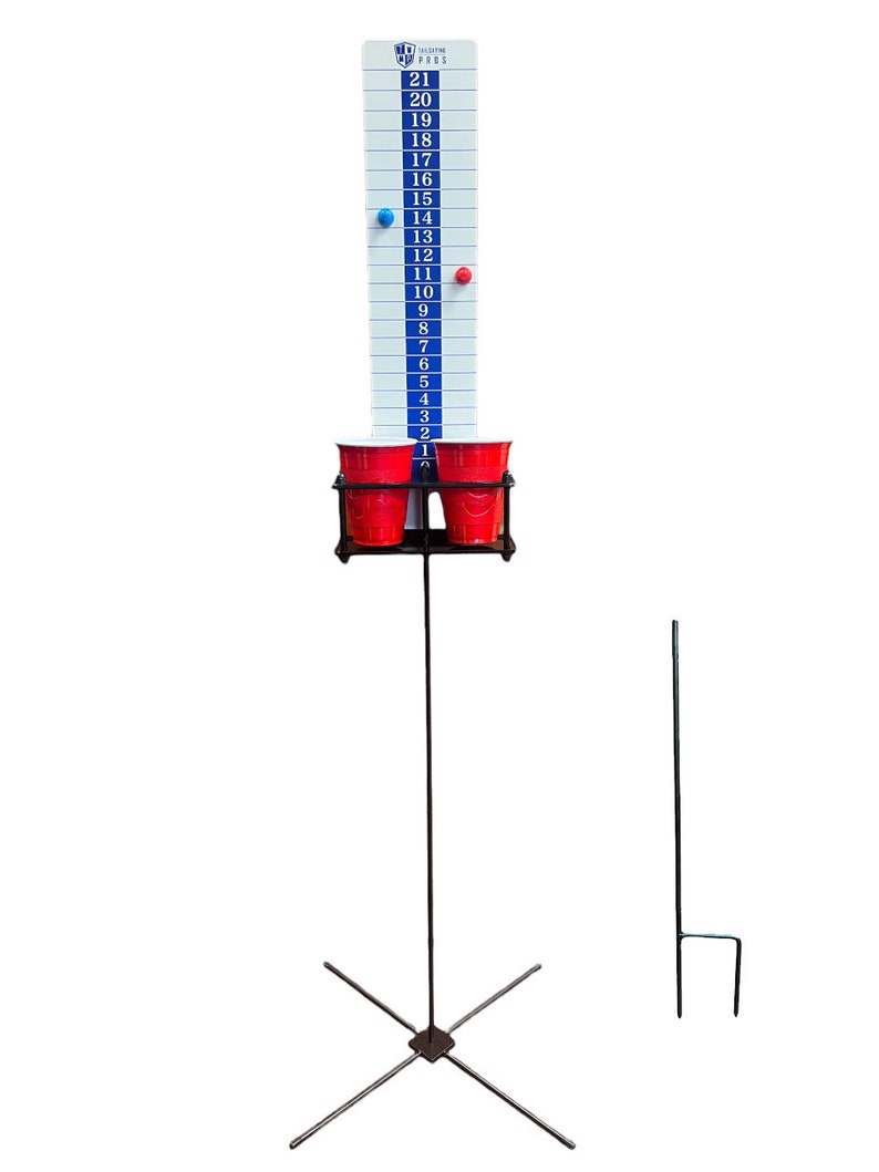 May include: A tall, white game board with blue and black markings, numbered from 1 to 21. Two red cups are held in a black metal frame. A blue and red magnet are attached to the board. The game is supported by a metal stand with an X-shaped base.