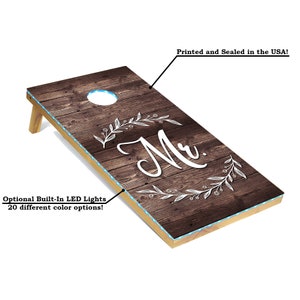 Woodgrain cornhole boards with "Mr." and "Mrs."