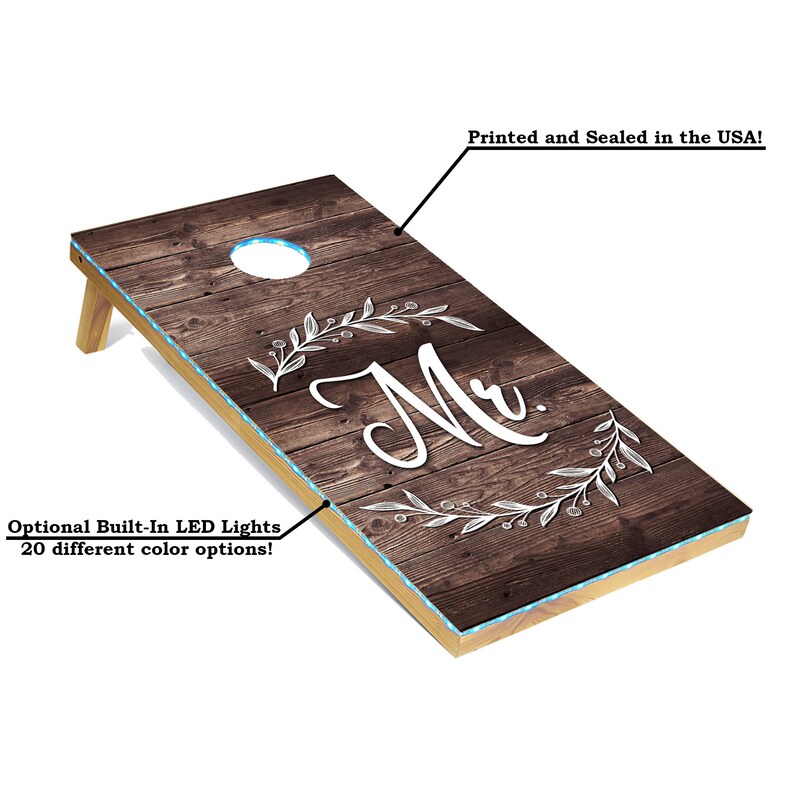 Woodgrain cornhole boards with "Mr." and "Mrs."