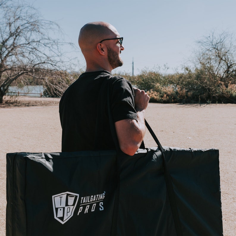 Cheers cornhole boards with two beer bottles clinking