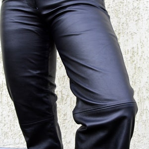 May include: Black leather pants with a smooth, shiny finish. The pants have a straight leg and a classic fit.