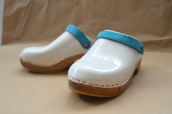 white wooden clogs