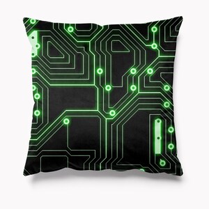 May include: A black and green throw pillow with a circuit board design. The circuit board is outlined in green and has glowing green lights.