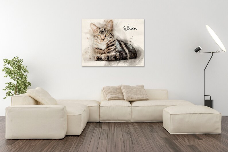 May include: Watercolor painting of a tabby cat with green eyes, lying down and looking to the right. The cat's name, "Whistler", is written in cursive in the top right corner of the painting.