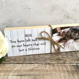 May include: A wooden block with a photo of a tabby cat and the text "SOX You have left paw prints on our hearts that will last a lifetime".