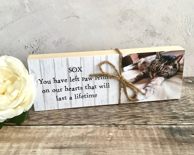 May include: A wooden block with a photo of a tabby cat and the text "SOX You have left paw prints on our hearts that will last a lifetime".