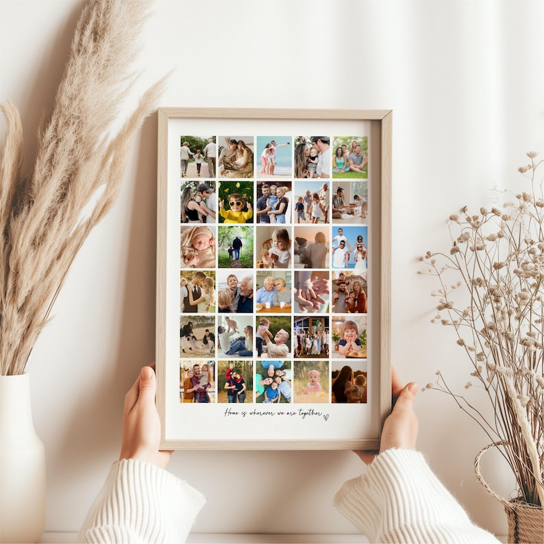 May include: A framed collage of family photos, held by a person. The photos are arranged in a grid pattern, showcasing various moments. The frame is light-colored, and the text "Home is wherever we are together" is at the bottom.