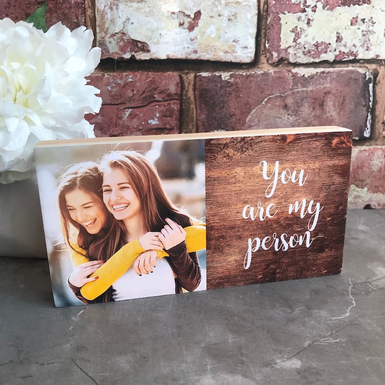 May include: A wooden block with a photo of two women smiling and hugging on one side and the text "You are my person" on the other side.