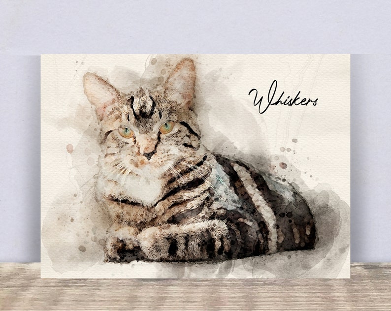 May include: Watercolor painting of a tabby cat with green eyes. The cat is lying down and looking at the viewer. The painting is titled "Whiskers".