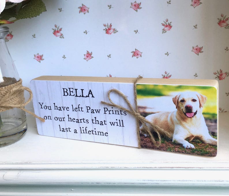 May include: Wooden memorial plaque with a photo of a dog and the text "Bella You have left Paw Prints on our hearts that will last a lifetime."