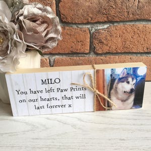 May include: Wooden block memorial with a photo of a white and grey dog and the text "MILO You have left Paw Prints on our hearts, that will last forever x"