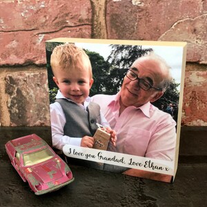 May include: A wooden photo block with a picture of a young boy and an older man. The text "I love you Grandad. Love Ethan x" is printed on the block.