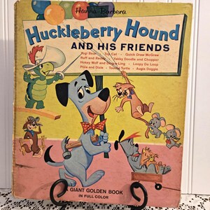 May include: Vintage "Huckleberry Hound and His Friends" Giant Golden Book in full color. The cover features cartoon illustrations of Huckleberry Hound and other characters. The book is displayed on a black metal stand.