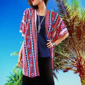 May include: A red, blue, and white patterned kimono with a geometric design. The kimono is worn over a black top and black pants.