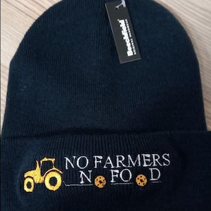 May include: Black beanie with a white embroidered tractor and the text "NO FARMERS NO FOOD". Three yellow circles are also embroidered on the beanie.