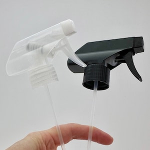 May include: Two plastic spray bottles, one clear and one black, with clear tubes extending from the bottom.
