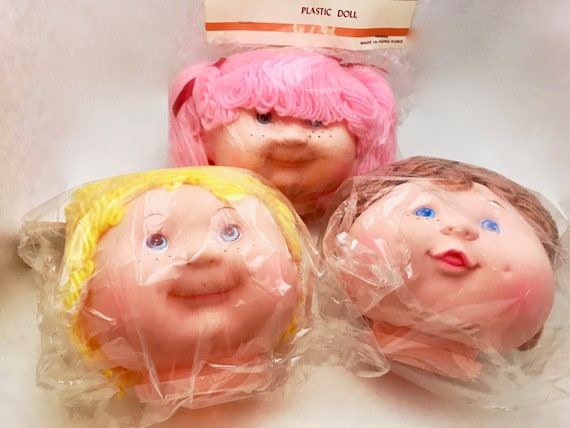 plastic dolls with big heads