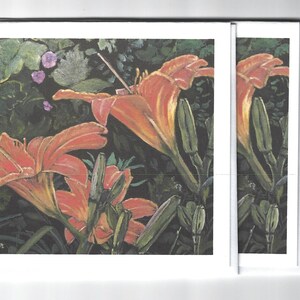 May include: A set of four greeting cards featuring a painting of orange lilies in a garden setting. The cards are blank inside and ready for your personal message. The artist's signature, "J.C. Callaghan", is visible in the bottom left corner of the card.
