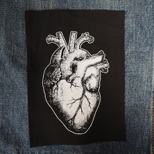 May include: A black and white anatomical heart illustration on a black fabric patch.