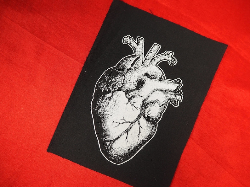 May include: Black and white anatomical heart illustration on a black fabric patch. The heart is detailed with veins and arteries.