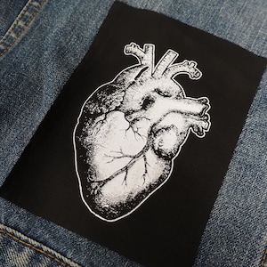 May include: Black and white anatomical heart illustration on a black fabric patch.