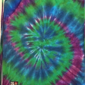 May include: A tie-dye drawstring bag with a green, blue, and purple swirl pattern. The bag has a small logo that says "Tie Dye House".