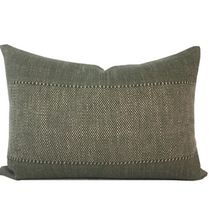 May include: A green rectangular pillow with a subtle woven pattern. The pillow has a light green border around the edges.