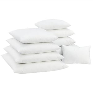 May include: A collection of white square and rectangular pillows. The pillows are stacked in a pile, with some arranged on top of each other. The pillows are made of a soft, fluffy material, and are likely for home decor or bedding.