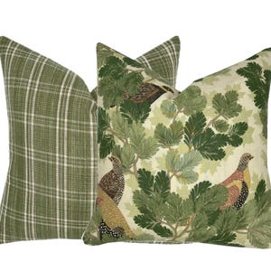 May include: Two decorative throw pillows with a green and white plaid pattern and a green and white floral pattern with birds.
