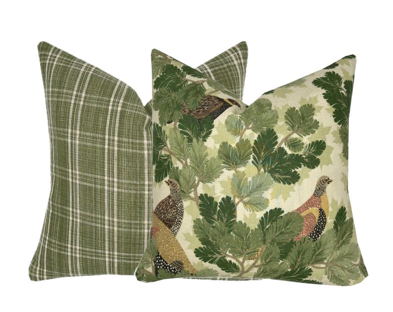 May include: Two decorative throw pillows with a green and white plaid pattern and a green and white floral pattern with birds.