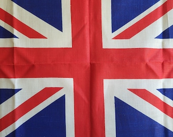May include: A square textile featuring the Union Jack, the national flag of the United Kingdom. The design includes a red cross and diagonal stripes on a white background, set against a blue field.