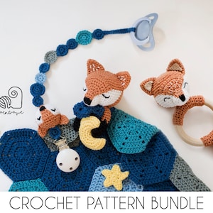 May include: Crochet pattern bundle for a baby blanket, two fox toys, and a teether. The blanket is blue, green, and grey with yellow stars. The foxes are orange and the teether is a wooden ring with a fox head.