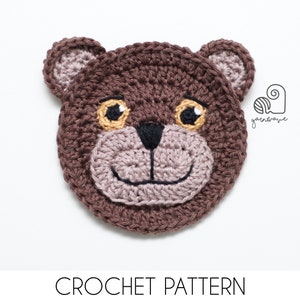 May include: Crochet pattern for a brown bear face with yellow eyes and a black nose. The pattern is available for download.