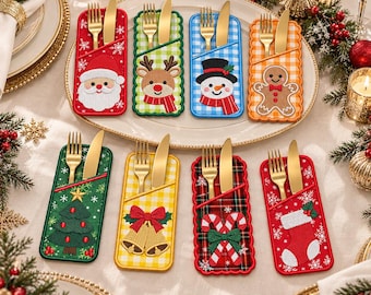 May include: Eight rectangular fabric cutlery holders featuring embroidered Christmas designs including Santa, a reindeer, a snowman, a gingerbread man, a tree, bells, candy canes, and a stocking, each holding a gold fork and knife.