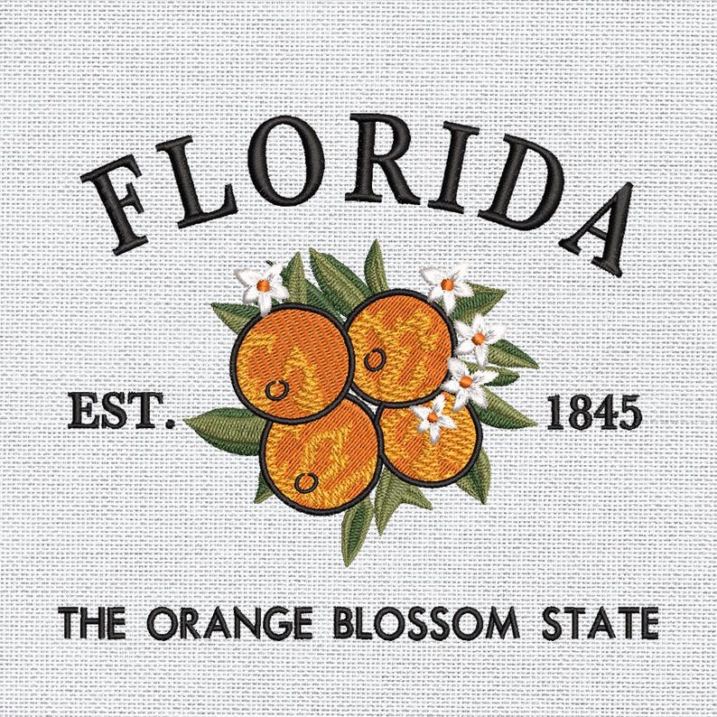 K&ouml;nnte beinhalten: Gesticktes Design mit dem Wort "FLORIDA" &uuml;ber Orangen, gr&uuml;nen Bl&auml;ttern und wei&szlig;en Bl&uuml;ten. Der Text "EST. 1845" und "THE ORANGE BLOSSOM STATE" sind ebenfalls enthalten. Das Design befindet sich auf einem hellgrauen, strukturierten Hintergrund.