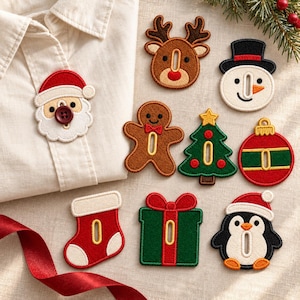 May include: A collection of embroidered Christmas-themed patches including a reindeer, snowman, gingerbread person, tree, ornament, stocking, gift, and penguin. One Santa patch is attached to a white shirt with a dark red button.