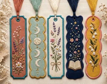 May include: Five rectangular fabric bookmarks with scalloped edges and tassels. Designs include a floral arrangement on terracotta, moon phases on sage green, wildflowers on cream, a book with stars on navy, and lily of the valley on yellow.