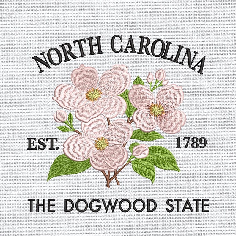 May include: Embroidered design featuring the words "North Carolina" above a floral arrangement of pink dogwood blossoms, green leaves, and the text "The Dogwood State." The year "1789" is also included.