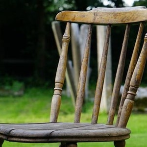 May include: A wooden chair with a slatted back and seat. The chair is made of natural wood and has a rustic look.