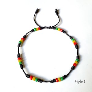 May include: A black string bracelet with red, yellow, and green beads. The bracelet is tied with a knot at the end. "Style 1" is written in the bottom right corner of the image.