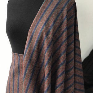 May include: Striped fabric in brown, blue, and red. The fabric has a diagonal stripe pattern.
